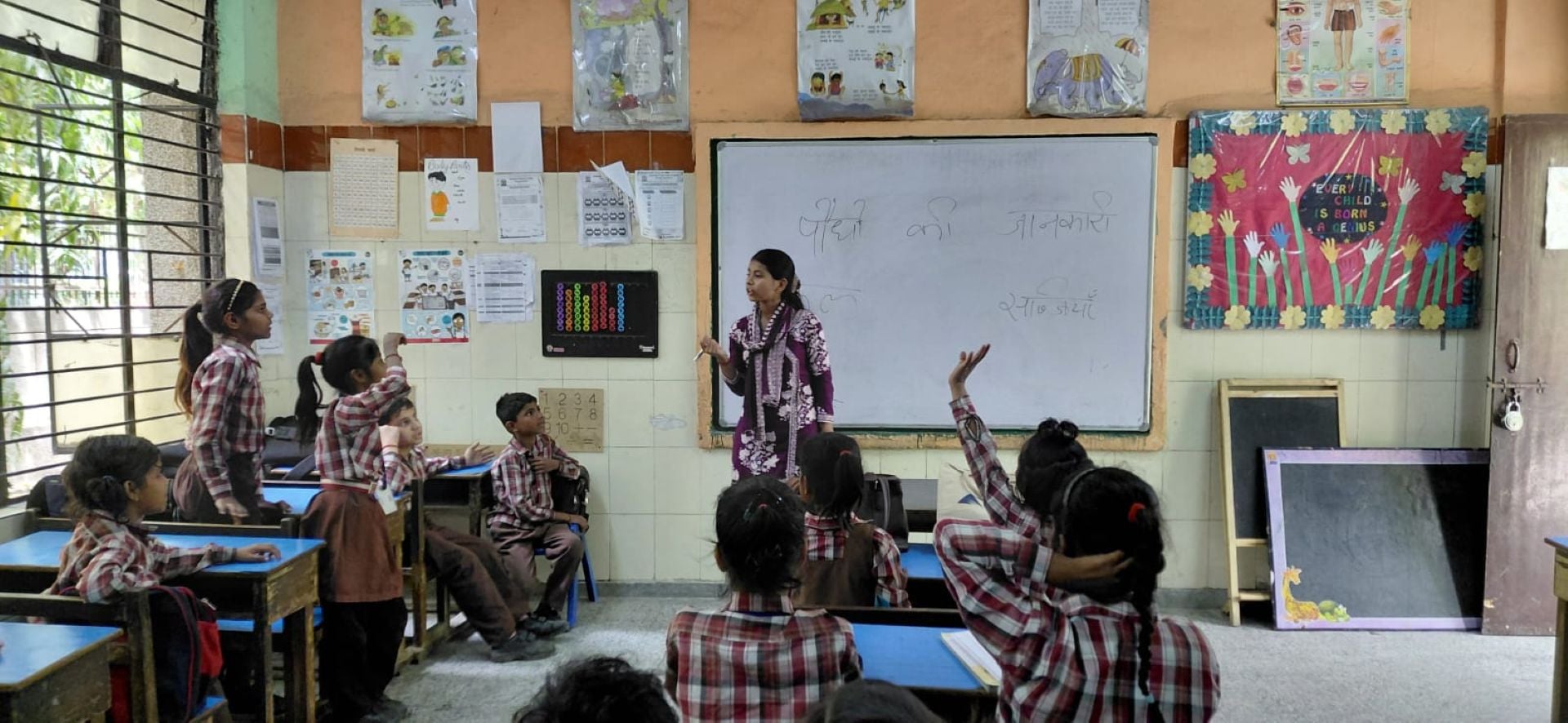 A Shikshadwar volunteer teaches a classroom about plants as part of an environmental-awareness session